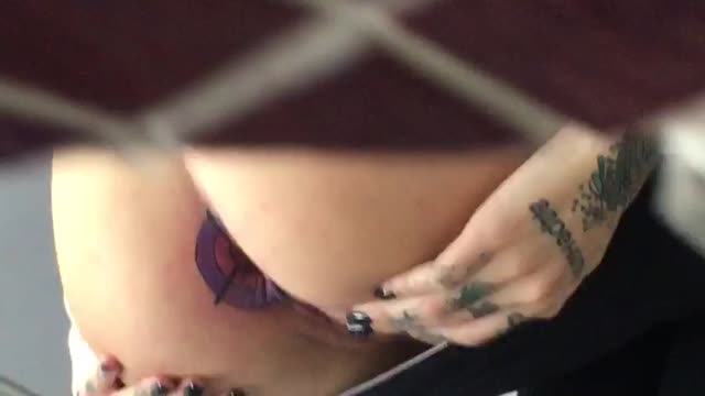 Girl getting anus tattoo