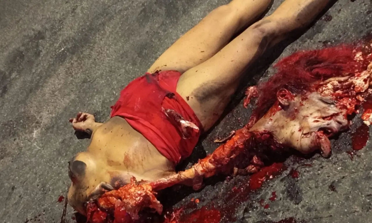 Gruesome aftermath of a collision between a bus and a woman