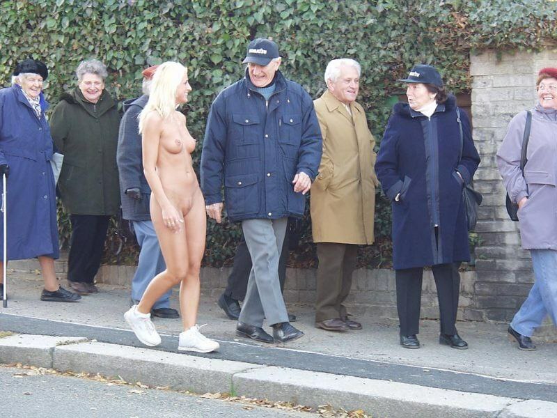 naked woman surrounded by elderly people