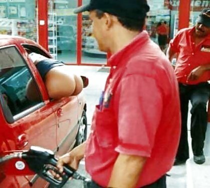 Butt hanging out the car window at the gas station.