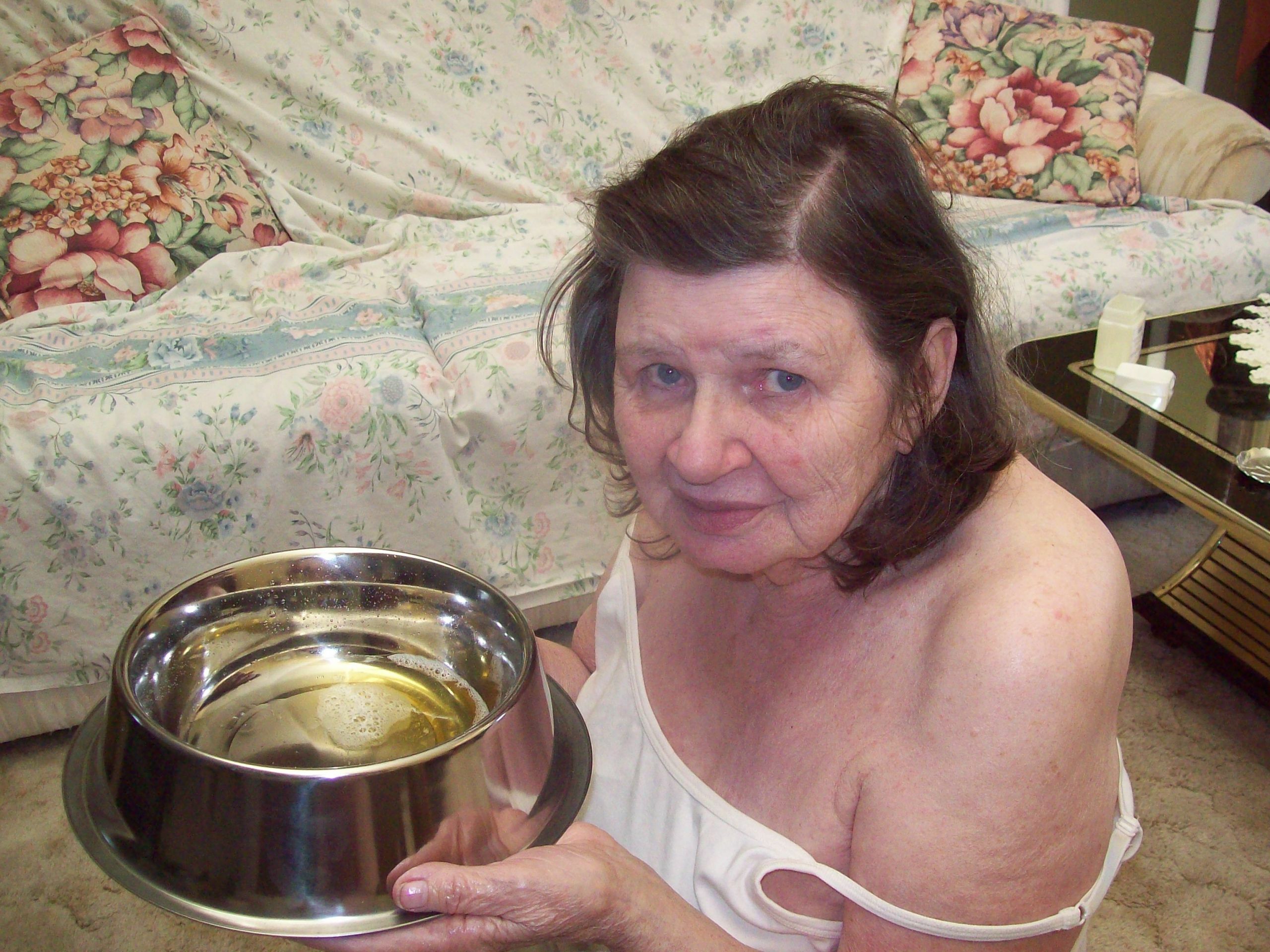 old woman drinks piss