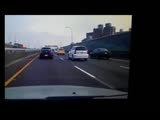 Flatbed truck gets a tank slapper after being brake checked and smashes cab first into wall