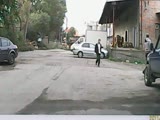 Man gets his ass kicked for throwing stones at a car.