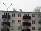 Man jumps from a five storey high building into the snow.