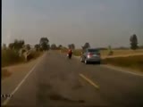 Car voilently smashes biker and end up in a ditch.