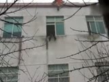 Rescuer jumps from a building to catch a suicidal woman.