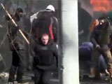 Fleeying riot policemen is knocked out with a stone to the head.