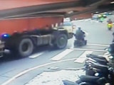 Man On A Motorised Scooter Drives Straight Under A Turning Cement Truck