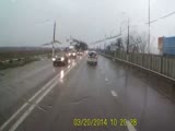 Speeding car in the rain slips and crashes into an oncoming truck.