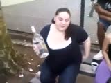 American girl drinks a bottle of vodka