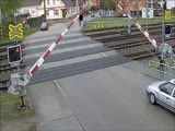 Man ignoring lights and the barriers is nearly killed by an oncoming train.