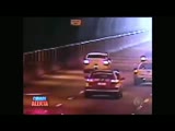 shocking motorbiker falls and is run over by a car in a tunnel.