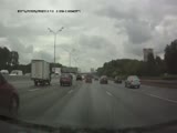 A motorbiker slides his way to death into the axel of a truck.