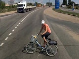 Woman On A Bicycle Tries To Outrun A Big Rig But Fails