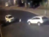 Pedestrian crossing the road is sandwiched to death by an out of control suv.