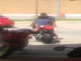 Woman crashes parked motorcycle into car.