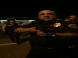 Police Officer pulls gun on journalists and unarmed protestors.