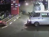 Out Of Control And Speeding Car Sweeps People Standing At A Gas Station.