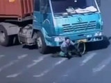 Cyclist Rides Straight Under A Huge Truck And Comes Out Unscathed