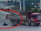 Biker Falls Directly Under A Trucks Wheels And His Helmet Pops Off From The Pressure