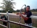 Redneck gets face full of firework while trying to shoot it in air with a bow