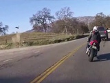 Overtaking Biker Flies Over A Barbed Wire Fence Into A Field To Avoid A Head On Collision