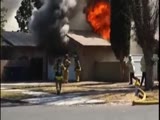 Firefighter falls through the roof of a burning home