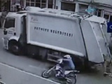 Biker Hits The Kerb And Falls Head First Under A Garbage Truck