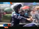 Mexican cop on the bike hits the crowd on parade