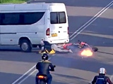 Speeding Biker Slides Under A Minibus While His Bike Catches Fire