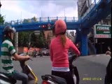 Ladies First! Gentleman guides chick on a scooter to red lights..