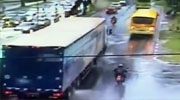 Biker Slips In The Rain And Goes Under The Wheels Of A Passing Truck