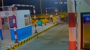 Car flips tires up in toll booth