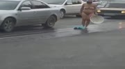 woman wash herself in the middle of the road