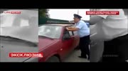 Cop takes a ride on the roof of the car