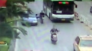 Taxi Driver Abruptly Opens His Door Sending A Female Scooter Rider Under The Bus