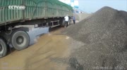 Truck driver dumps tons of rock, sand on officer