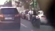 Driver Opens His Car Door Sending Biker Under The Wheels Of A Passing Car