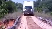 Truck tries to cross wooden bridge and fails