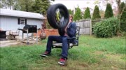 Idiot breaks his hand catching tire thrown by his mate