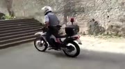 Cop on the bike climbs the stair and fall on top