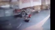 Guy miraculously avoids getting crushed by Truck