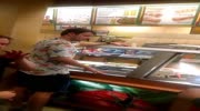 Guy breaks glass showcase with his head while fight in fastfood