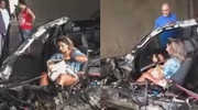 Woman Sitting Unscathed In A Total Car Wreck