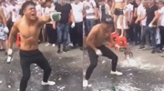 Chinese Nutcase Smashes Numerous Beer Bottles On His Head For A Baying Crowd