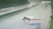 Bus overturns on a wet highway