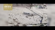 Footage: Heavy rain and hail turn streets into rivers in NE China