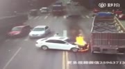 Car starts to burn after being hit by 2 trucks