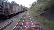 Cross biker narrowly escapes death under train