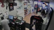 Thieves are locked inside Cell phone store as people laugh and point.